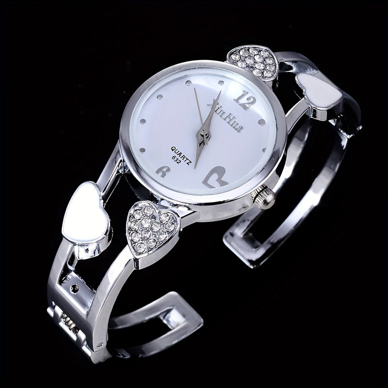 Round pointer quartz watch, rhinestone decorated dial, hollowed out heart detail on the watch strap 