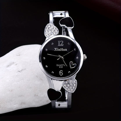 Round pointer quartz watch, rhinestone decorated dial, hollowed out heart detail on the watch strap 