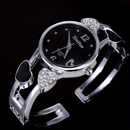 Round pointer quartz watch, rhinestone decorated dial, hollowed out heart detail on the watch strap 